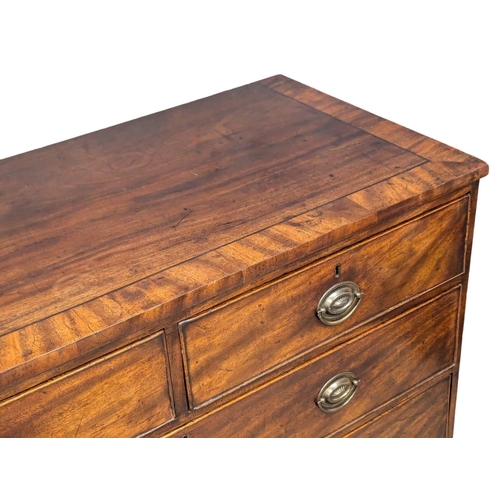 953 - A Late George III inlaid mahogany chest of drawers on sprayed bracket feet. Circa 1800-1810. 107x50x... 