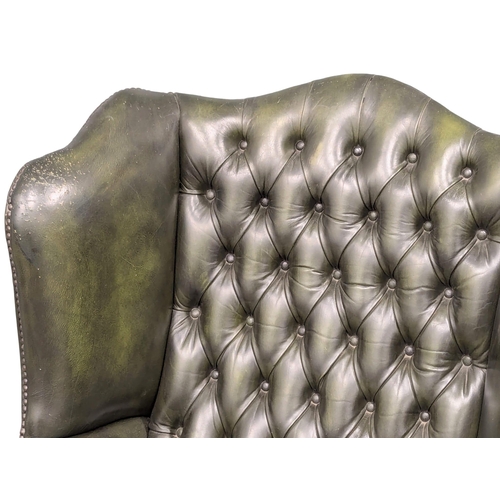 957 - A leather 2 seater wingback sofa. 130cm(6)