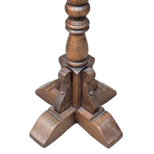 961 - A Old Charm oak pedestal plant stand. 27x92cm (1)