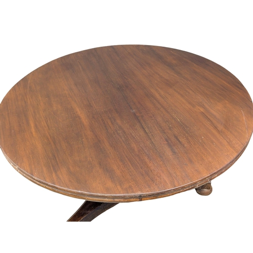 976 - A William IV mahogany tilt top breakfast table / dining table. 131x73cm(3)