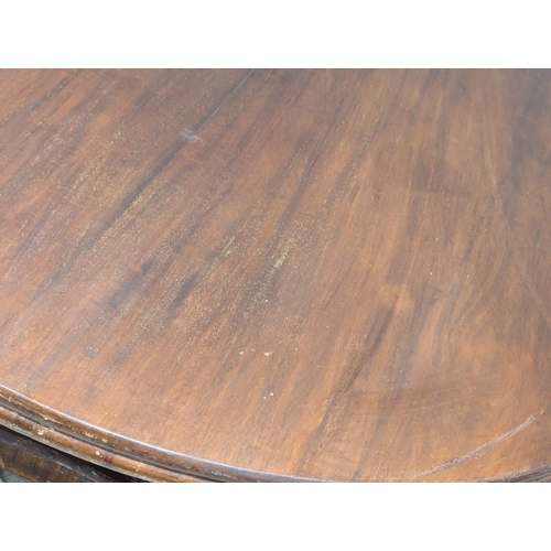 976 - A William IV mahogany tilt top breakfast table / dining table. 131x73cm(3)