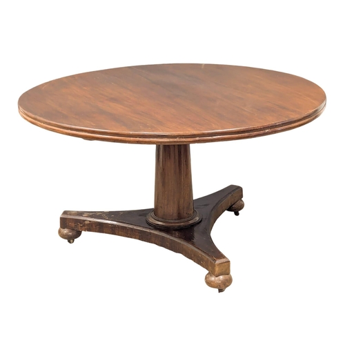 976 - A William IV mahogany tilt top breakfast table / dining table. 131x73cm(3)