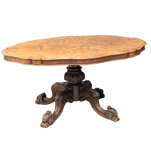 999 - A Victorian walnut tilt top breakfast table / dining table. 146x110x71cm (3)