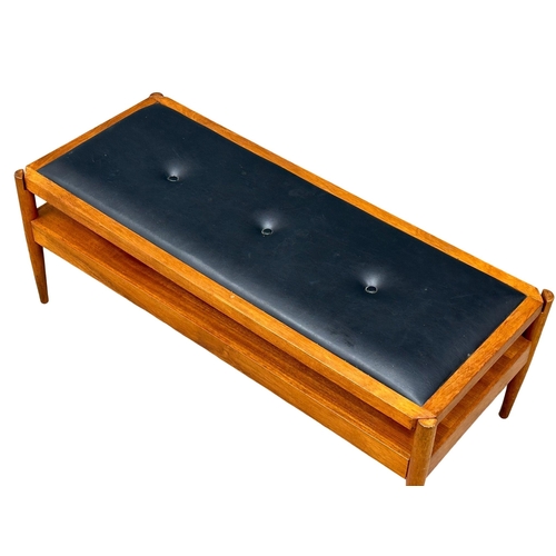 807 - A Mid Century teak turnover coffee table bench. With black vinyl top. Pleasing Furniture by PYE-Fran... 