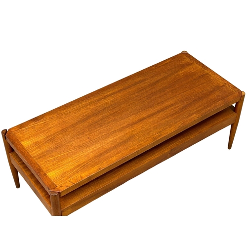 807 - A Mid Century teak turnover coffee table bench. With black vinyl top. Pleasing Furniture by PYE-Fran... 