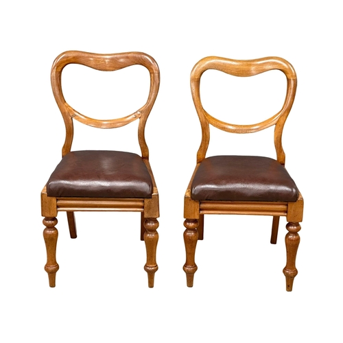 901 - A pair of Victorian balloon back chairs, with leather seats and turned legs. 19th Century. Circa 187... 