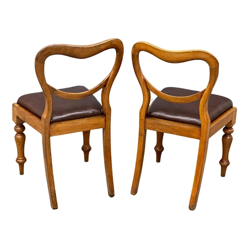 901 - A pair of Victorian balloon back chairs, with leather seats and turned legs. 19th Century. Circa 187... 