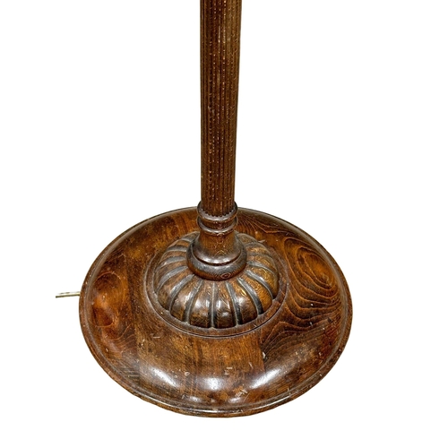 903 - A good quality 1930’s oak standard lamp with reeded column and original shade. 178cm(10)