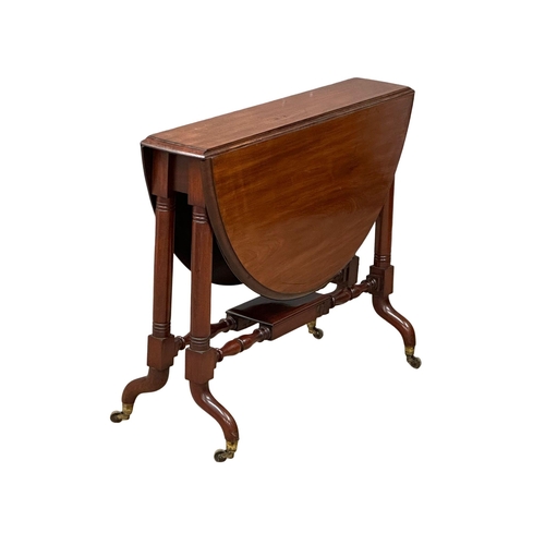 905 - A large Victorian mahogany Sutherland table. Double stretcher support on brass cup casters. 19th Cen... 