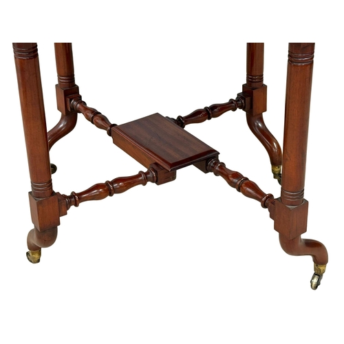 905 - A large Victorian mahogany Sutherland table. Double stretcher support on brass cup casters. 19th Cen... 