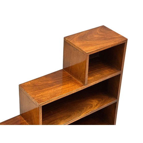 926 - A Mid 20th Century mahogany stepping open bookcase. 106.5x25.5x91.5cm.(10)