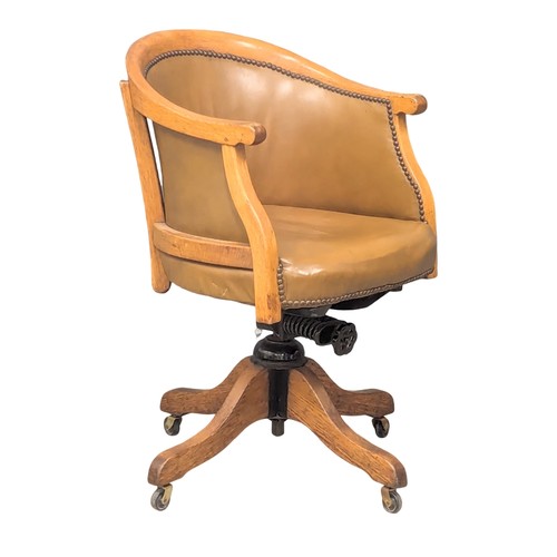 987 - An Early 20th Century oak swivel desk chair with oringal leather seat. Circa 1900.(1)