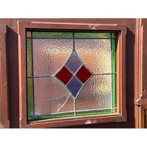 813 - A very large mahogany framed double sided panel with 3 stained glass windows. 245x204cm