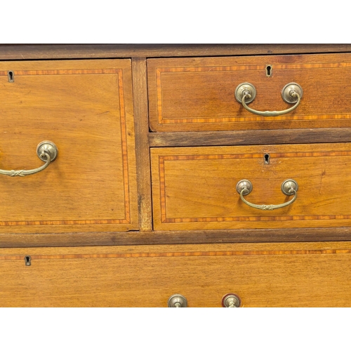 921A - A large Edwardian inlaid mahogany chest of drawers with gallery back. Circa 1910. 121x57x127cm. 1