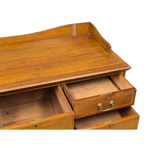 921A - A large Edwardian inlaid mahogany chest of drawers with gallery back. Circa 1910. 121x57x127cm. 1