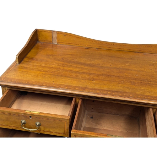 921A - A large Edwardian inlaid mahogany chest of drawers with gallery back. Circa 1910. 121x57x127cm. 1