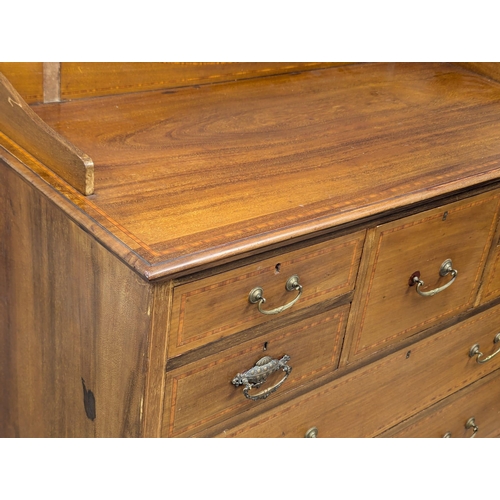 921A - A large Edwardian inlaid mahogany chest of drawers with gallery back. Circa 1910. 121x57x127cm. 1