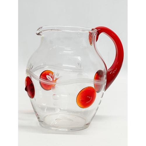 508 - A 1930’s water jug with ruby glass handle and etched glass ground. 17x14x16cm.