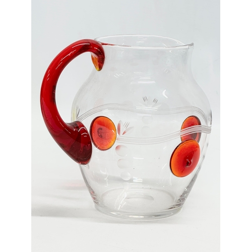 508 - A 1930’s water jug with ruby glass handle and etched glass ground. 17x14x16cm.