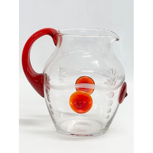 508 - A 1930’s water jug with ruby glass handle and etched glass ground. 17x14x16cm.