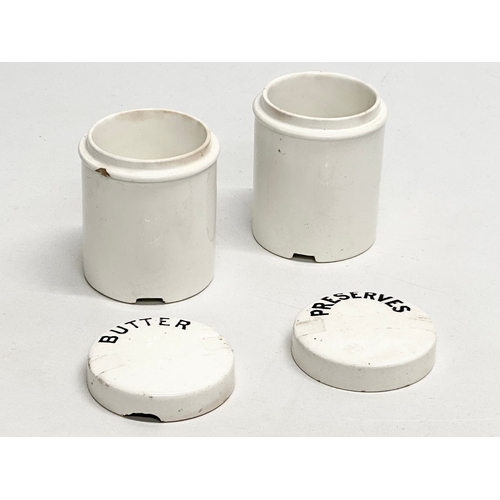 513 - A pair of Early 20th Century ceramic preserve jars. Butter & Preserves. Marks CWS & S. 8x10cm.