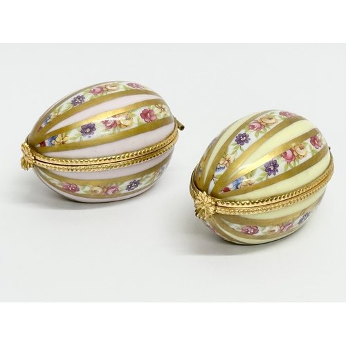 521 - Dubarry, Limoges. Two hand painted porcelain egg shaped trinket boxes, Dubarry Limoges, France. Incl... 