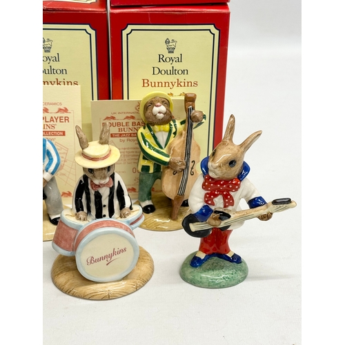 890 - 11 Royal Doulton Bunnykins The Jazz Band Collection, together with a Royal Doulton Rock and Roll Bun... 