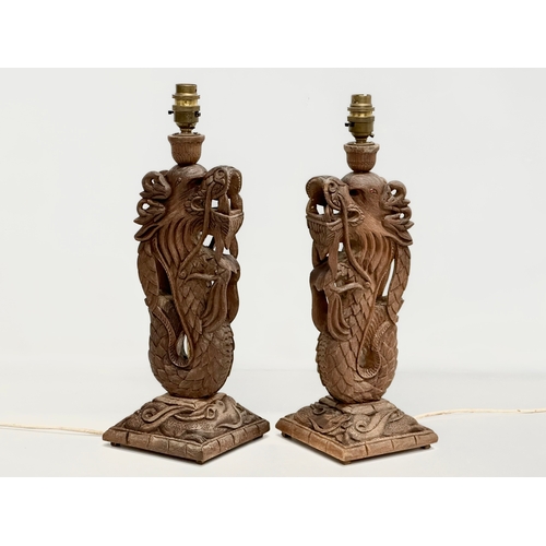 40 - A pair of Early 20th Century Chinese carved teak dragon table lamps. Circa 1920-1930. 15x14x43cm