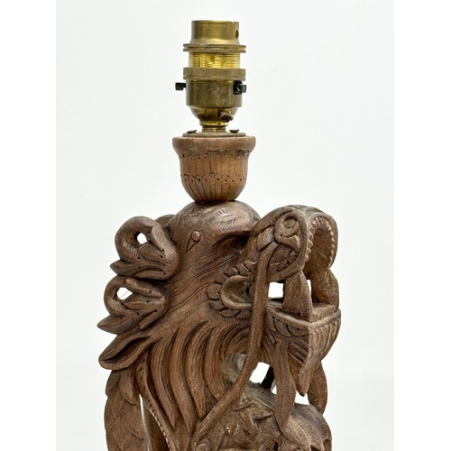 40 - A pair of Early 20th Century Chinese carved teak dragon table lamps. Circa 1920-1930. 15x14x43cm