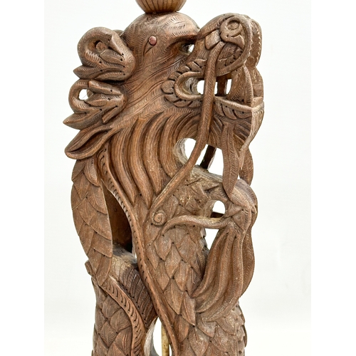 40 - A pair of Early 20th Century Chinese carved teak dragon table lamps. Circa 1920-1930. 15x14x43cm