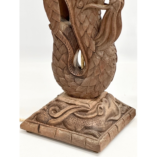 40 - A pair of Early 20th Century Chinese carved teak dragon table lamps. Circa 1920-1930. 15x14x43cm