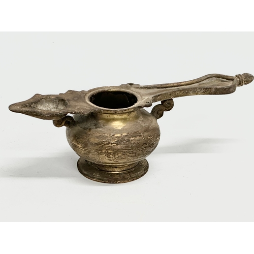 110 - A 19th Century Indian brass oil lamp. 25x9x8cm