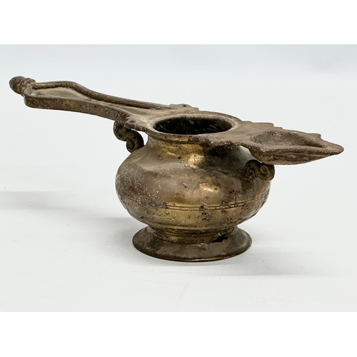 110 - A 19th Century Indian brass oil lamp. 25x9x8cm