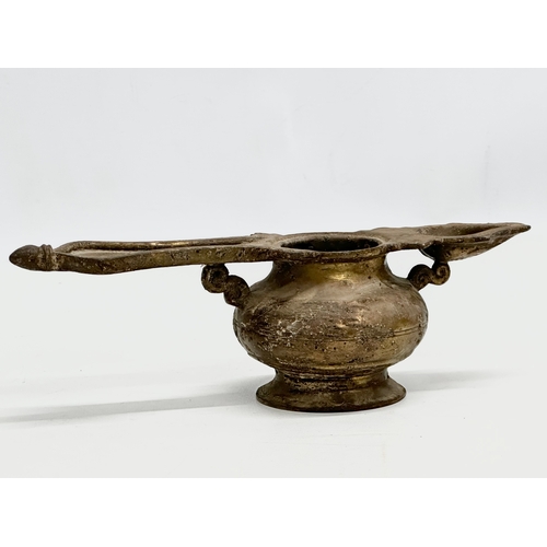 110 - A 19th Century Indian brass oil lamp. 25x9x8cm