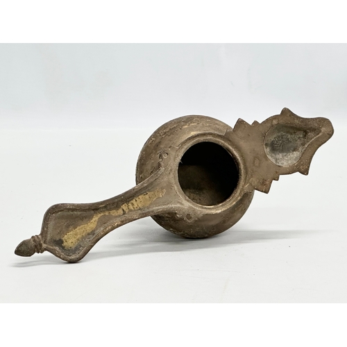 110 - A 19th Century Indian brass oil lamp. 25x9x8cm