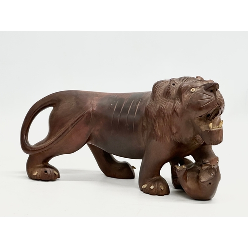 86 - An Early 20th Century carved boxwood lion and pray. 28x15cm