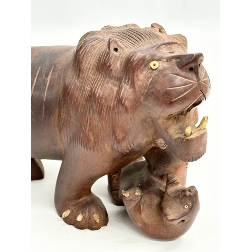 86 - An Early 20th Century carved boxwood lion and pray. 28x15cm