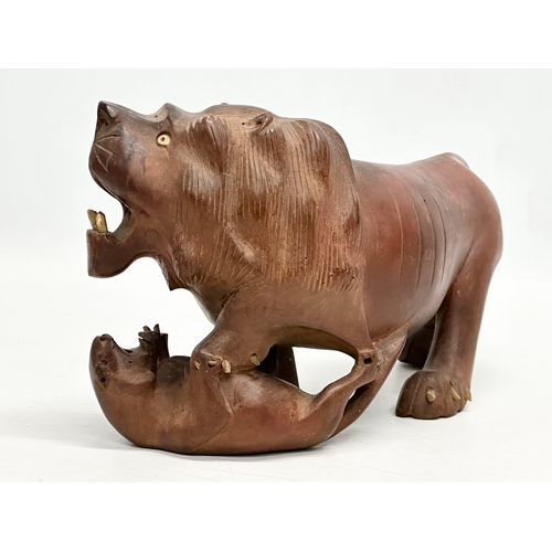 86 - An Early 20th Century carved boxwood lion and pray. 28x15cm