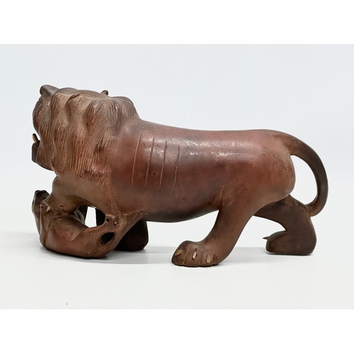 86 - An Early 20th Century carved boxwood lion and pray. 28x15cm