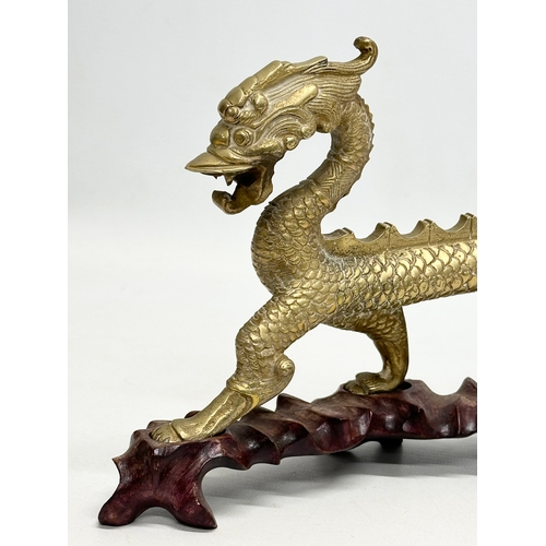 29 - A large Early/Mid 20th Century Chinese brass dragon on stand. 35x16cm