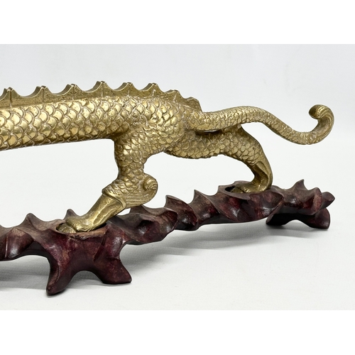 29 - A large Early/Mid 20th Century Chinese brass dragon on stand. 35x16cm