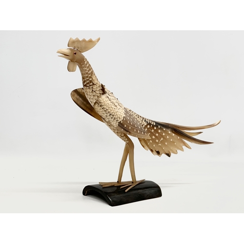 95 - A large Mid 20th Century carved horn bird on stand. 36x30cm