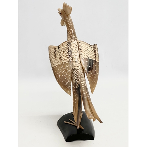 95 - A large Mid 20th Century carved horn bird on stand. 36x30cm