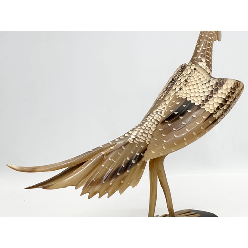 95 - A large Mid 20th Century carved horn bird on stand. 36x30cm