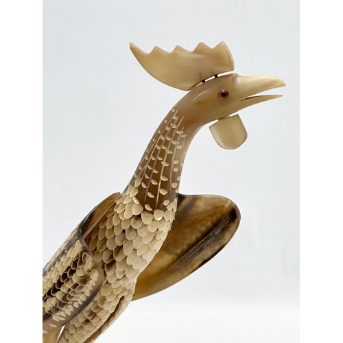 95 - A large Mid 20th Century carved horn bird on stand. 36x30cm