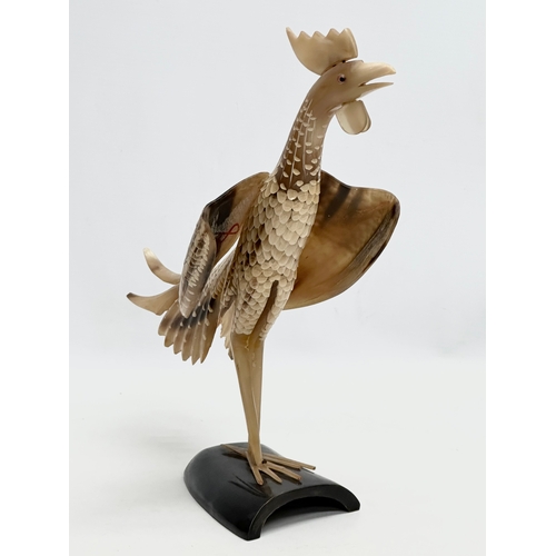 95 - A large Mid 20th Century carved horn bird on stand. 36x30cm