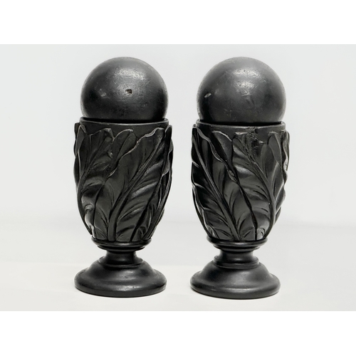 61 - A pair of 19th Century carved ebony garnitures with removable balls and carved Acranthus leaf decora... 