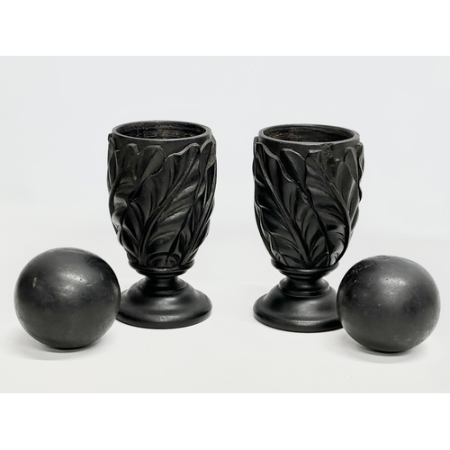 61 - A pair of 19th Century carved ebony garnitures with removable balls and carved Acranthus leaf decora... 