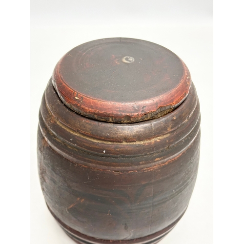 16 - Riga Ware. A 17th/18th Century turned wooden tobacco barrel jar. 11x15cm.