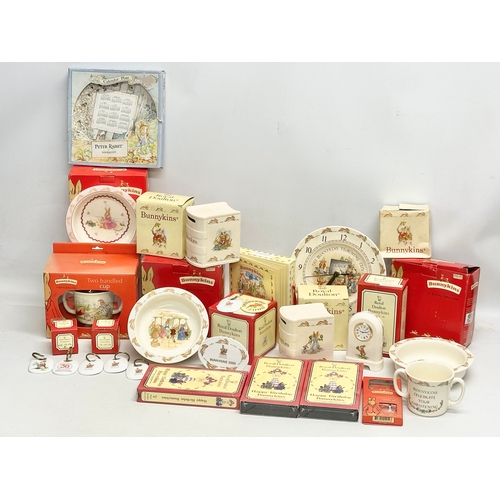 906 - A collection of Royal Doulton Bunnykins. Plates, clocks, money banks, key rings, cups etc